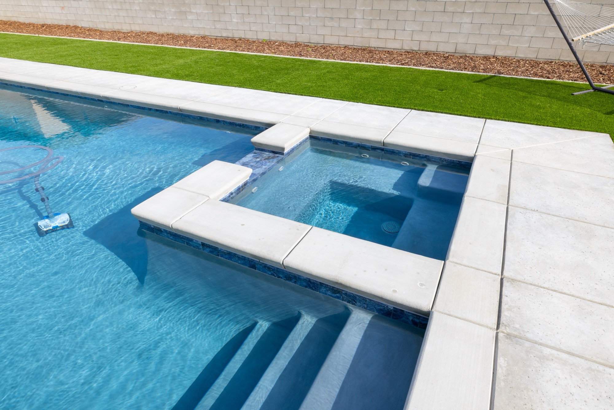 Spa spillover and sun shelf detail on a custom gunite pool