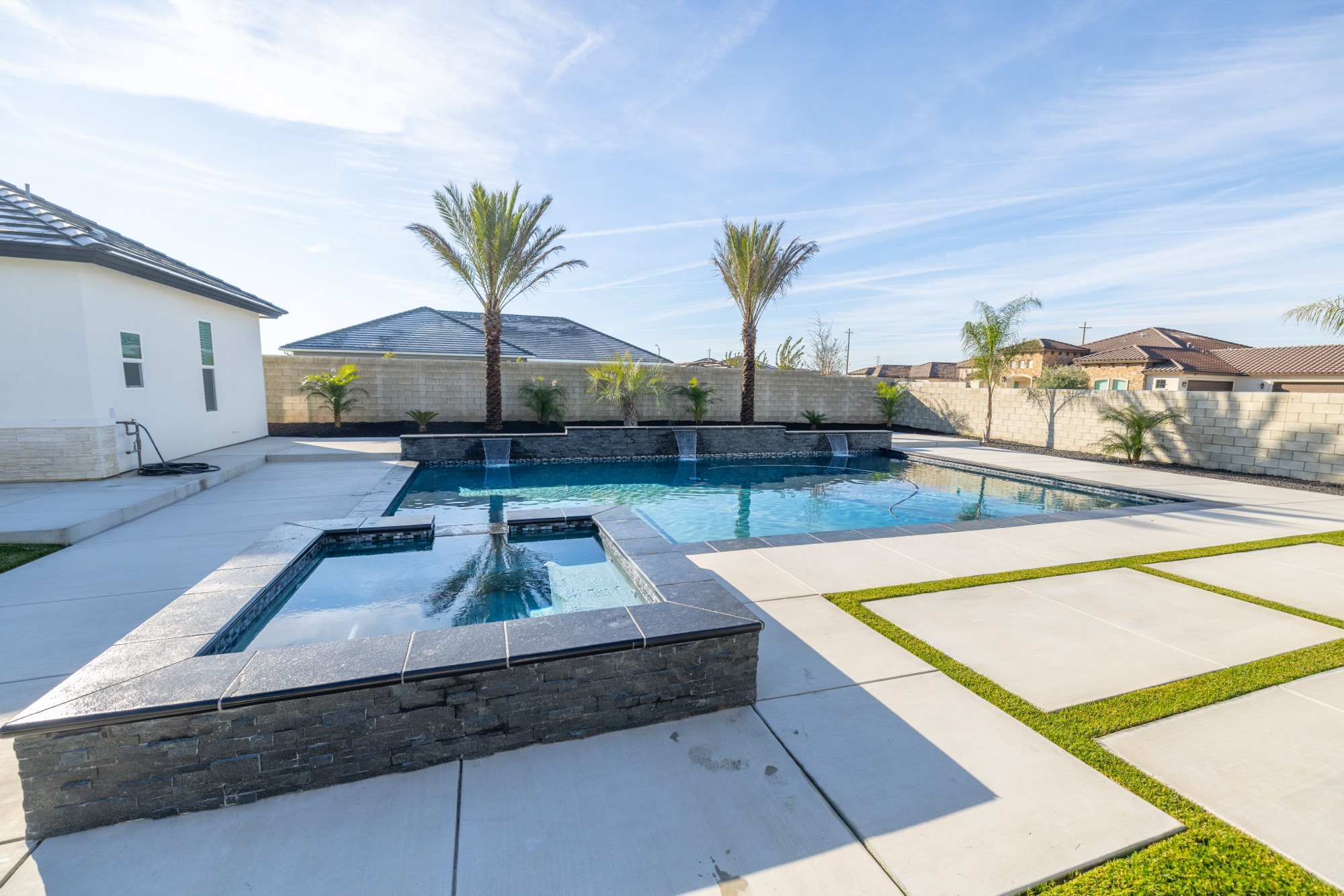 Custom gunite pool with raised spa and dual waterfall features — Bakersfield, CA