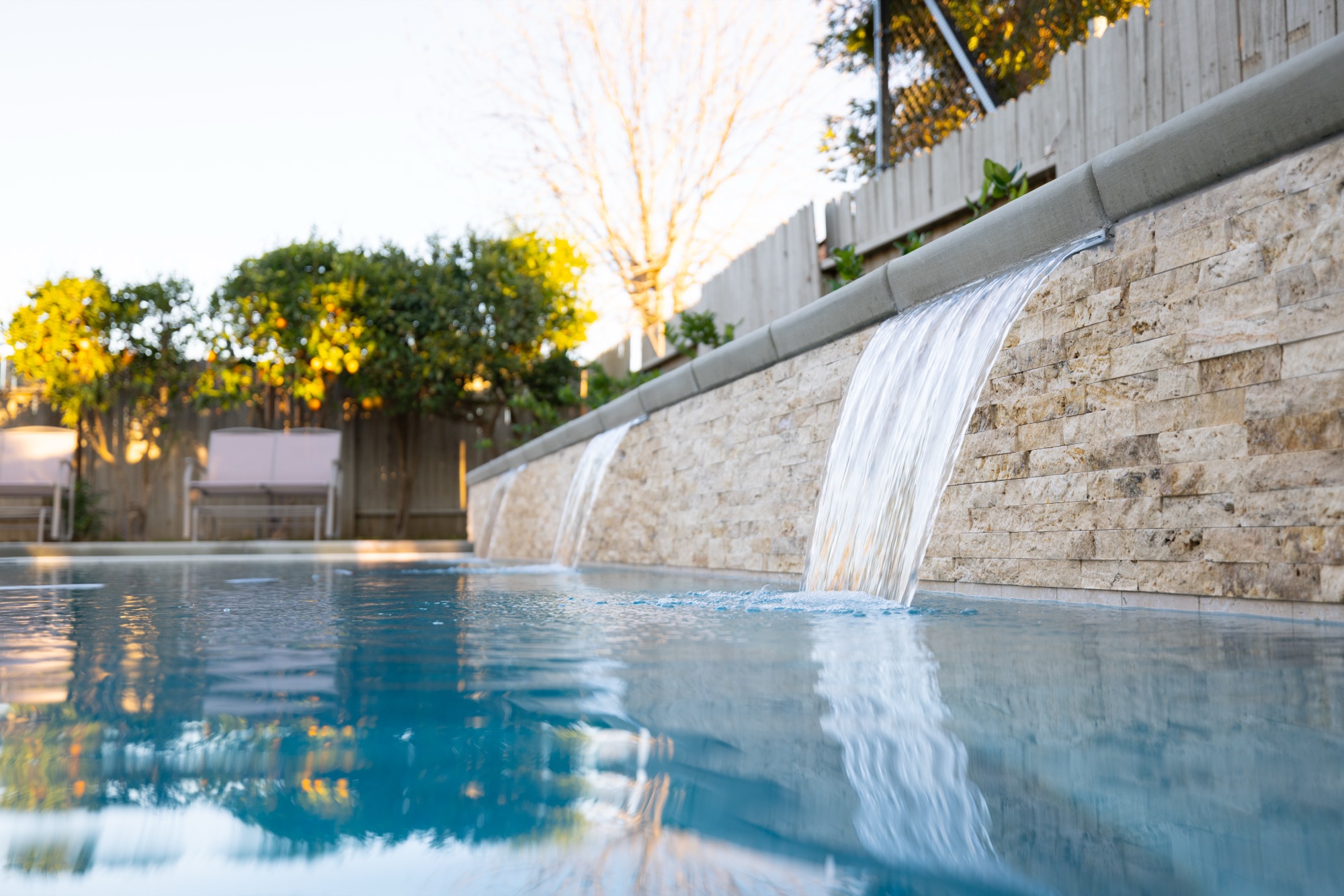 Stone waterfall water feature on gunite pool